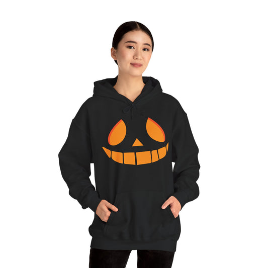 Person wearing a black hoodie with a pumpkin face design on a white background