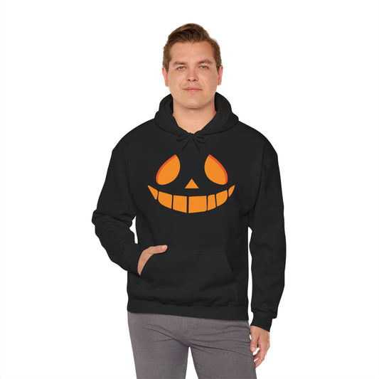 Person wearing a black hoodie with a pumpkin face design on a white background