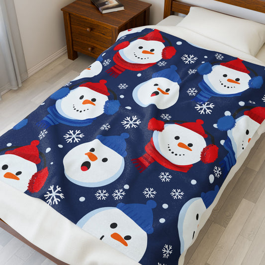 Christmas-themed blanket with snowmen on a bed in a bedroom.