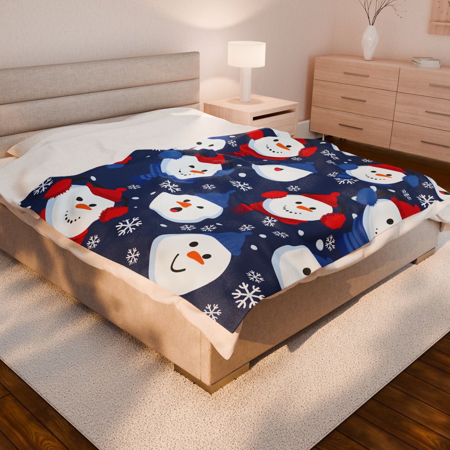 Bed with a snowman-themed blanket in a bedroom setting