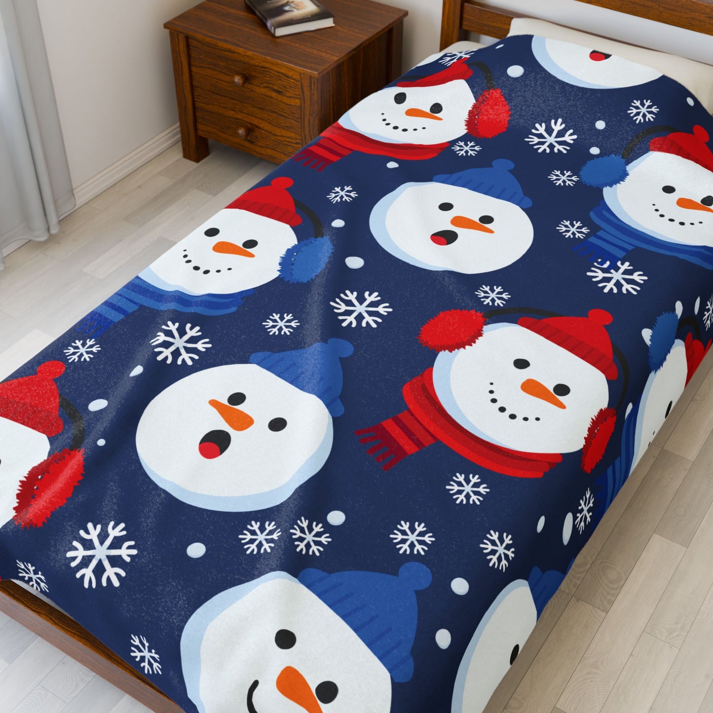 Bedspread with snowman pattern on a bed in a room.