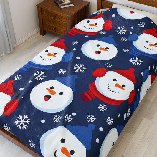 Bedspread with snowman pattern on a bed in a room.
