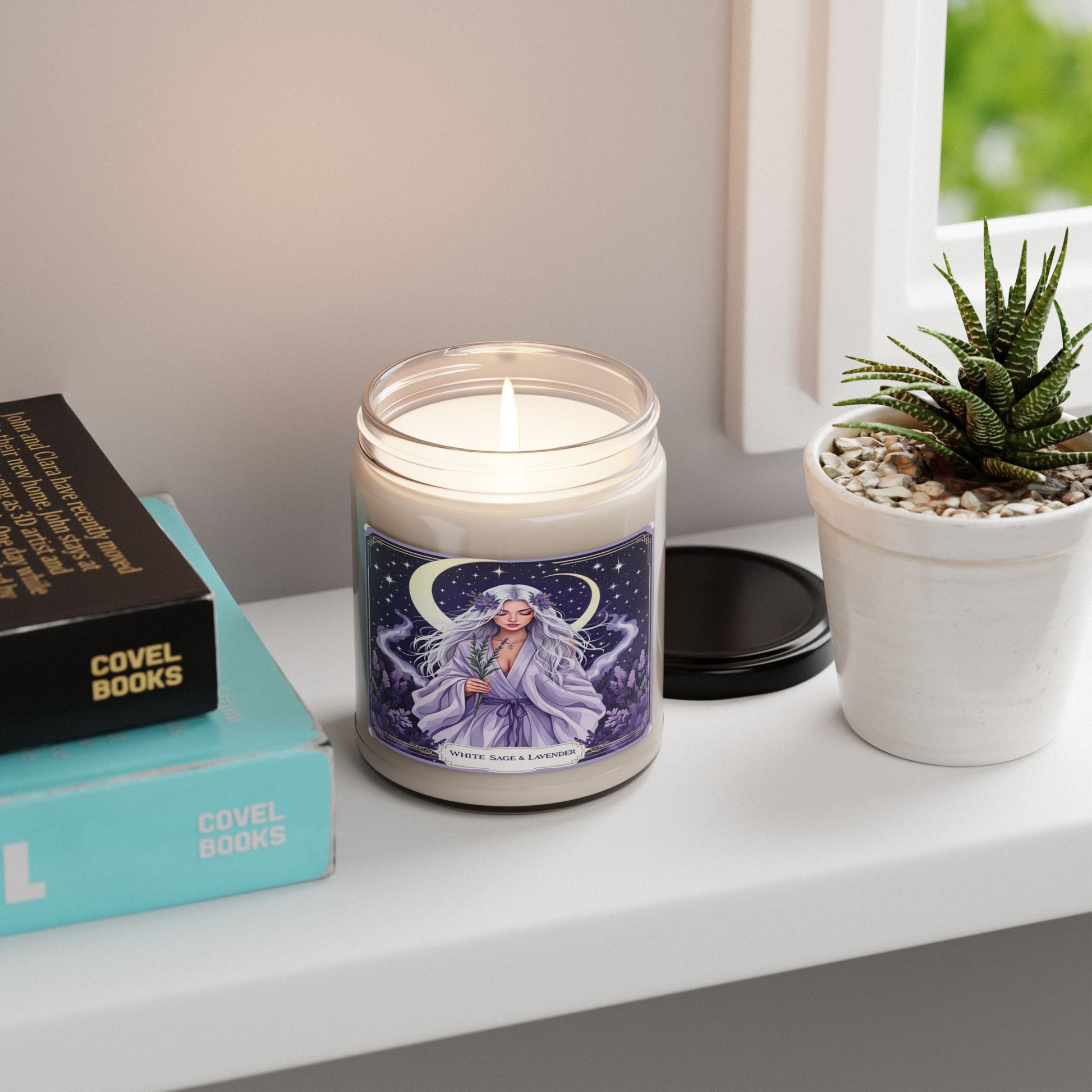 Candle with a decorative label on a shelf next to books and a plant