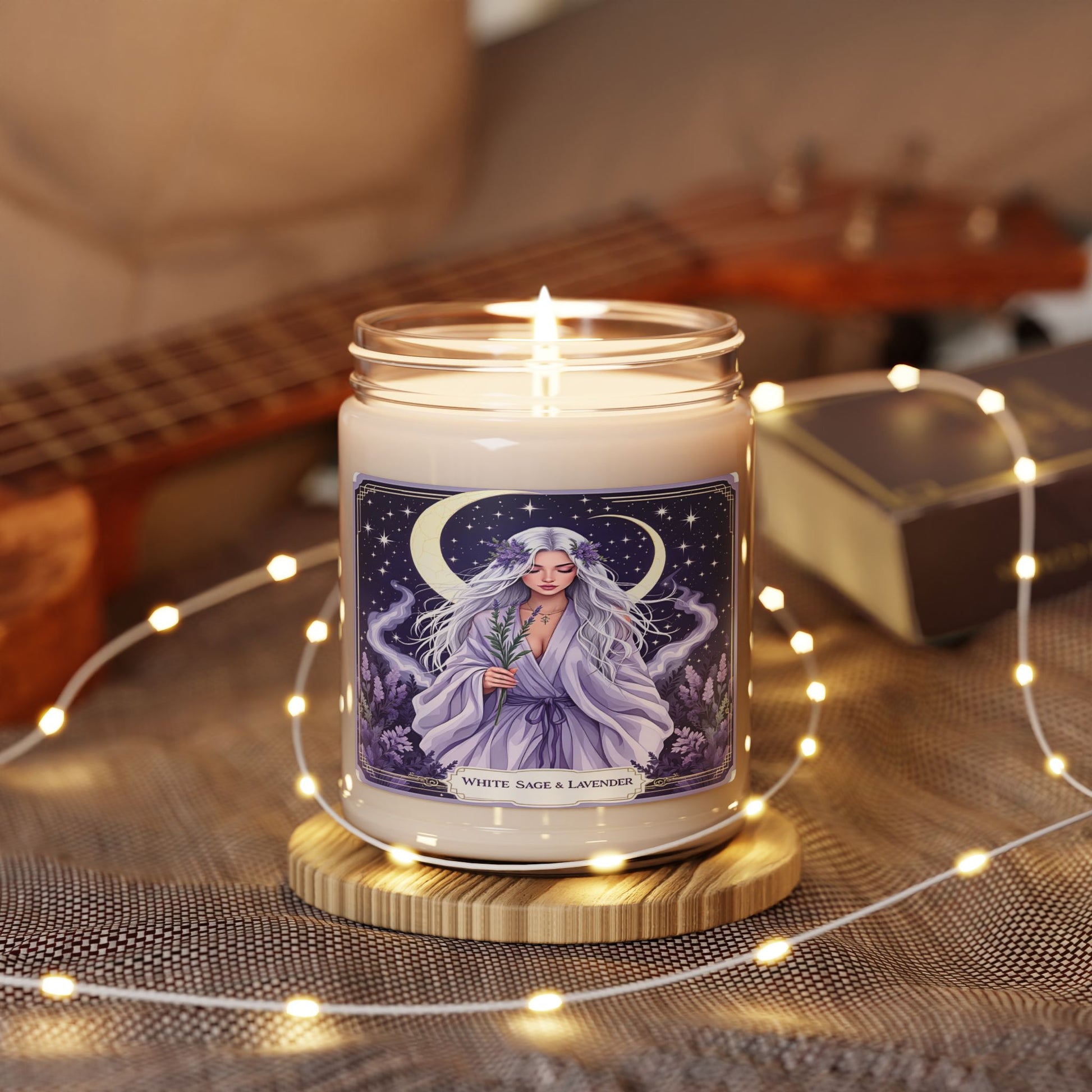 Candle with a decorative label on a wooden coaster surrounded by string lights and a guitar in the background