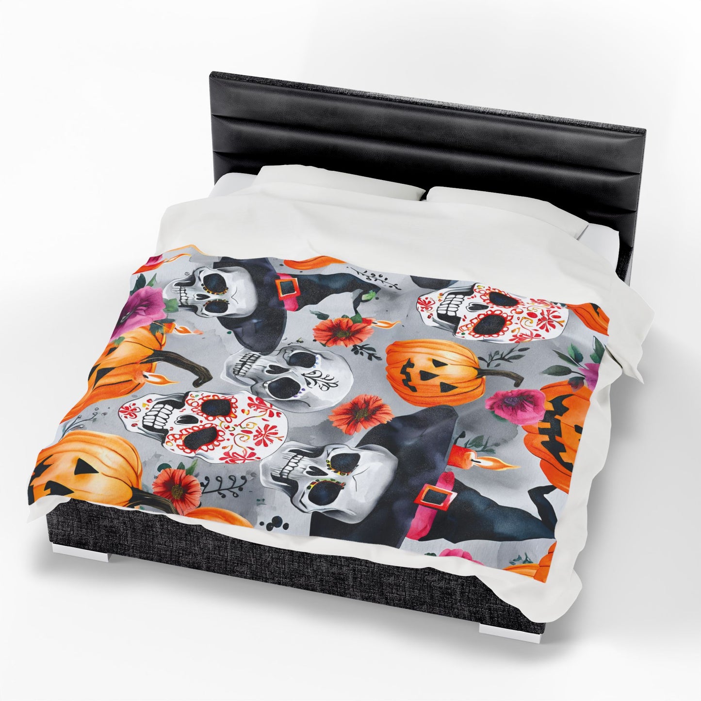 Halloween-themed bedding set with skulls, pumpkins, and flowers on a bed.