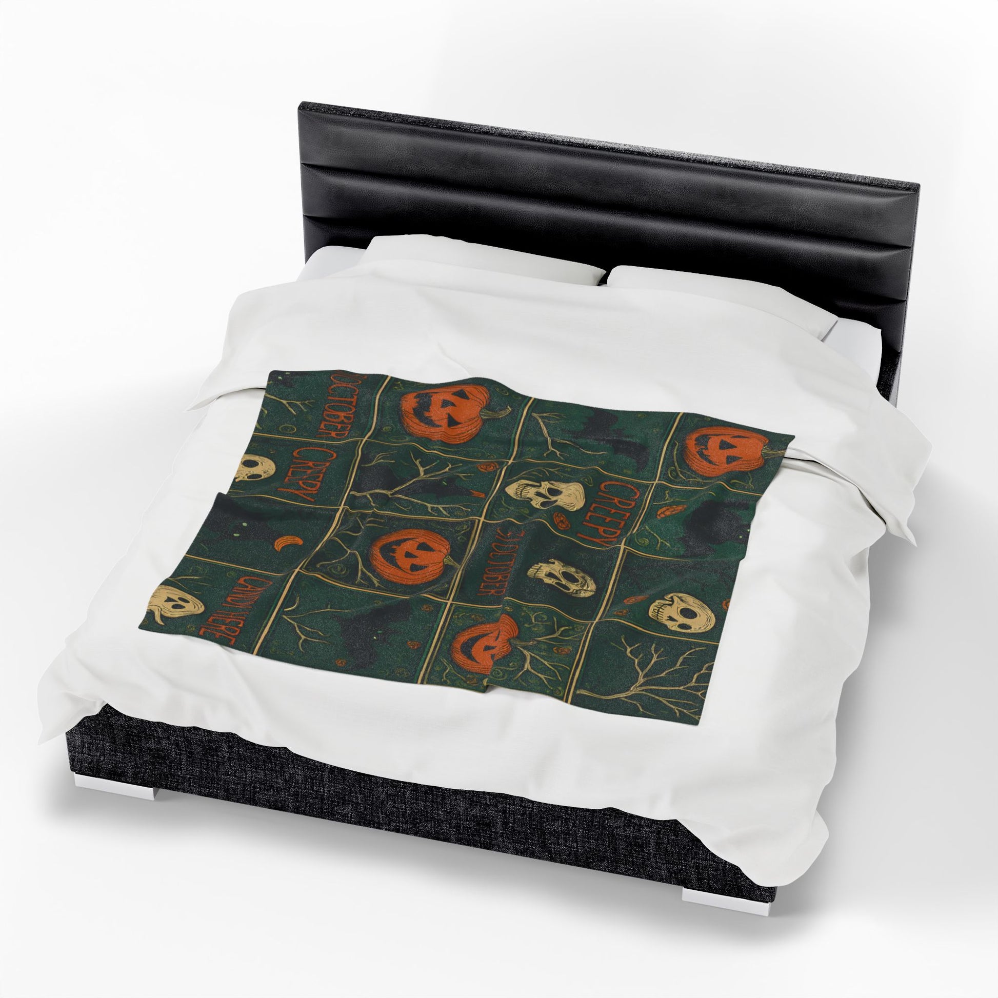 Halloween-themed bedding set on a bed with a black headboard.